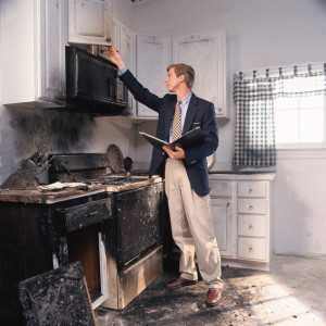 dr_person_assessing_kitchen_fire_damage